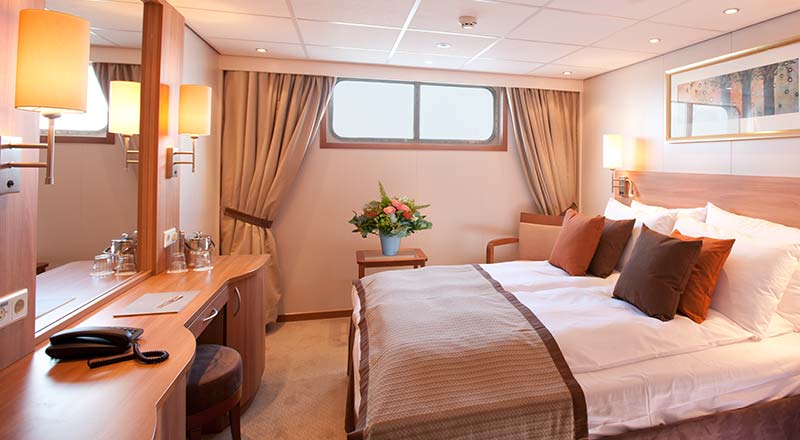 Bed of a Standard stateroom on board a Viking river ship
