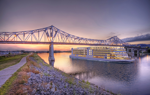 Viking Mississippi sailing under a bridge